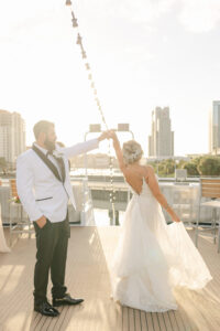 Groom Spinning Bride Sunset Wedding Photo | Tampa Bay Wedding Venue Yacht StarShip