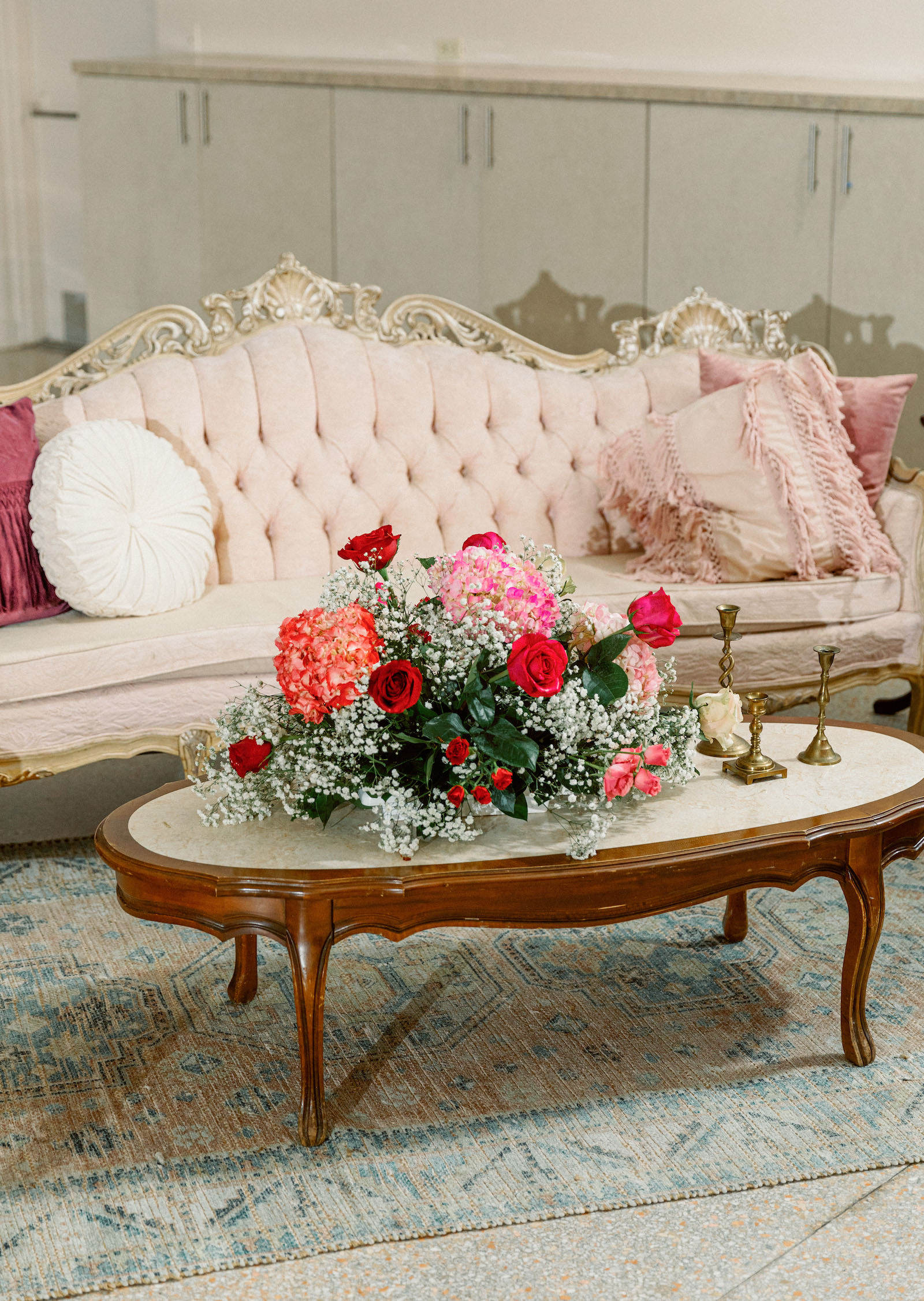 Fairytale Private Residence Wedding Reception Decor, Vintage Gold and Pink Tufted Couch, Antique Coffee Table with Lush Babys Breathe, Red Roses and Pink Hydrangeas Floral Centerpiece | Tampa Bay Wedding Photographer Dewitt for Love Photography | Wedding Florist Lemon Drops