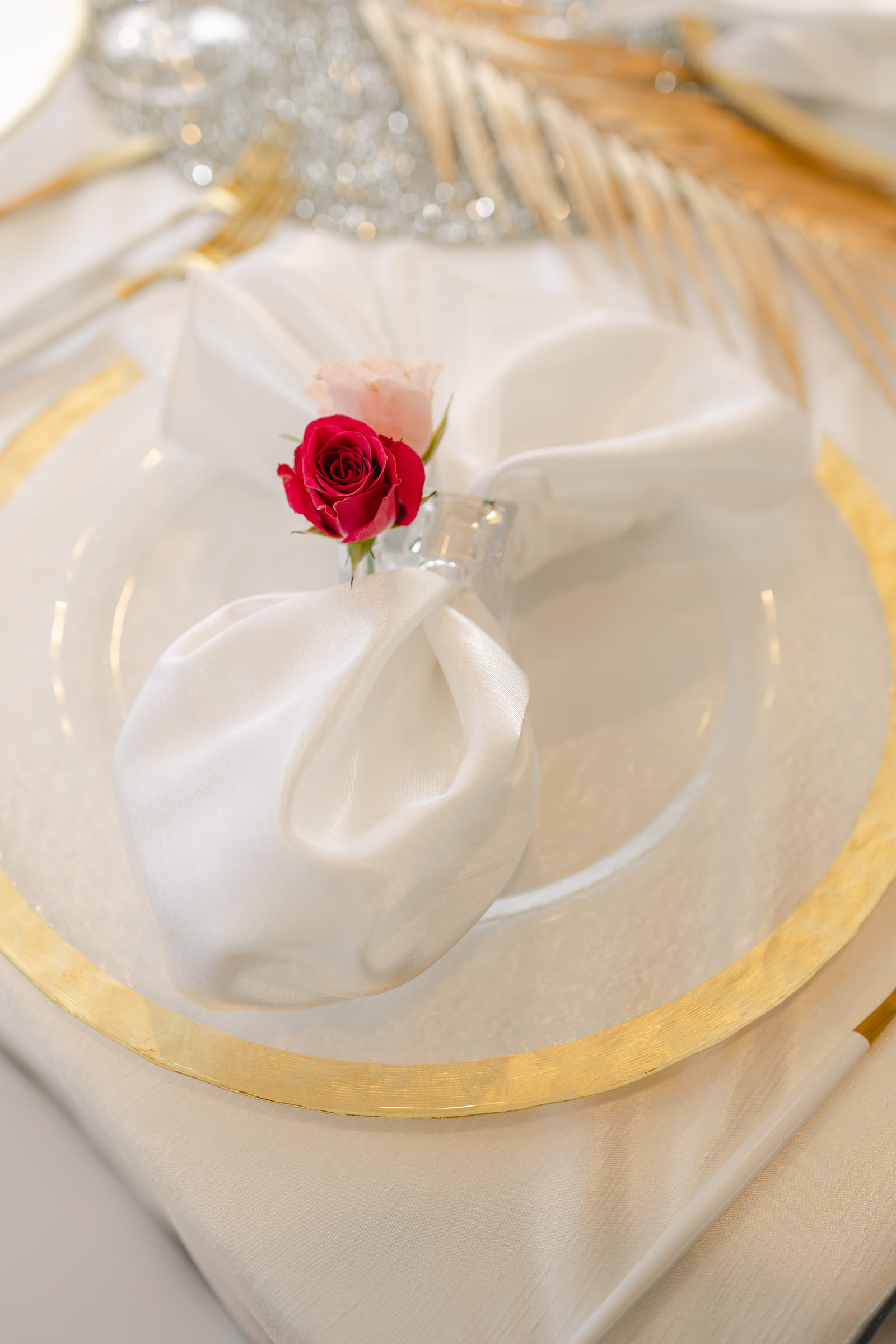 Modern Tropical Wedding Reception Decor, Gold Rimmed Charger, White Table Napkin with Red Rose Ring Holder | Tampa Bay Wedding Rentals Kate Ryan Event Rentals