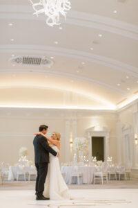Timeless Classic Bride and Groom Dance in Empty Ballroom Before Guests Arrive Wedding Reception Portrait