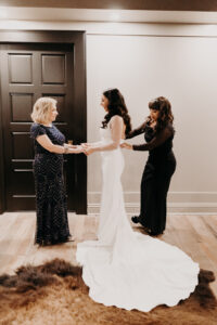 Bride Getting Ready with Mother's of the Bride in Long Sleek Fitted Wedding Gown with Sheer Sleeves | Tampa Hair and Makeup Artist Michele Renee the Studio
