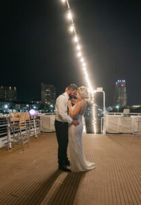 Bride and Groom Nighttime Portrait Dancing Under String Lights on Tampa Wedding Venue Yacht StarShip