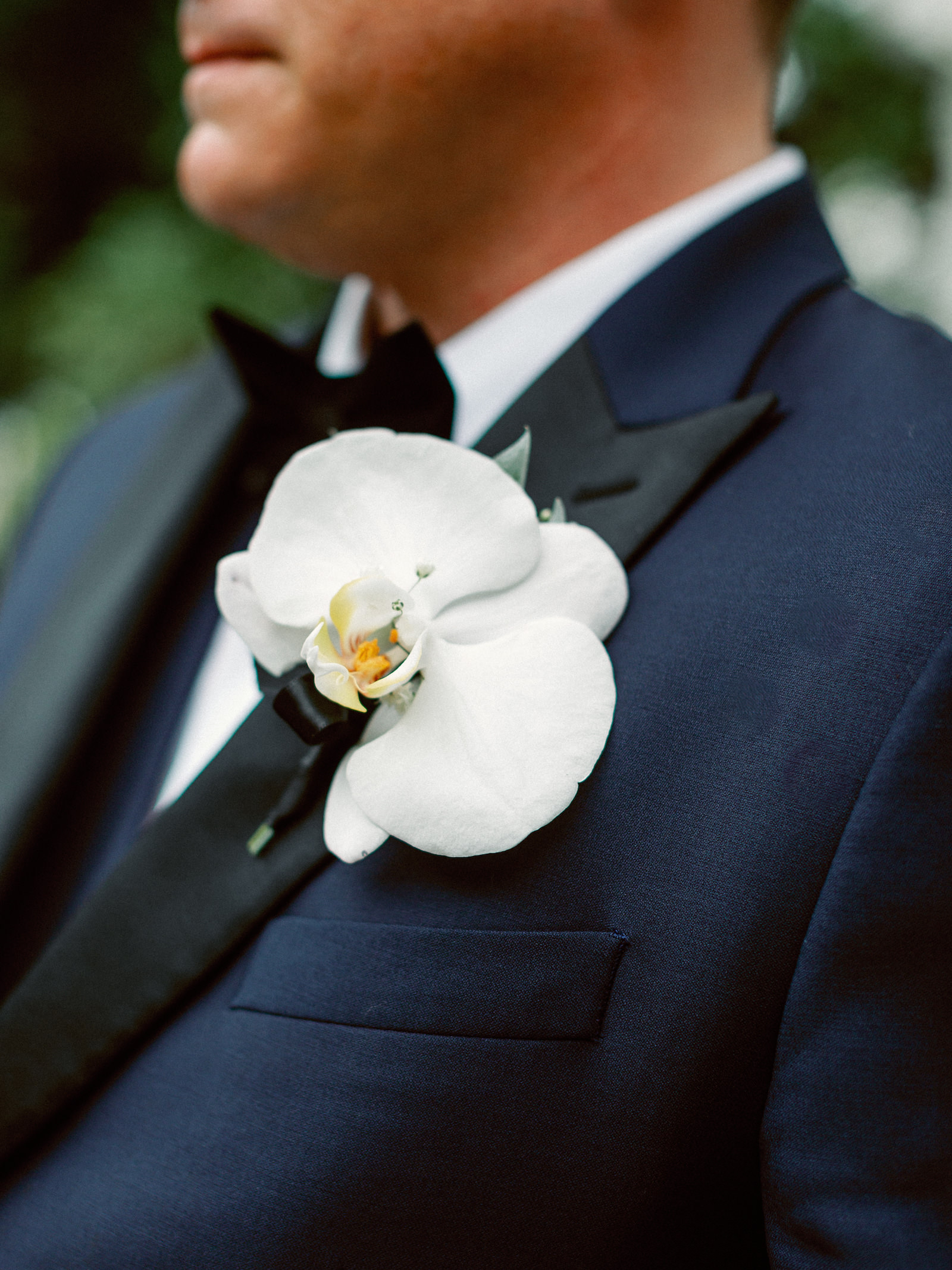 Fairytale Red and Pink Wedding, Groom Wearing Navy Blue with Black Collar Tuxedo, White Orchid Boutonniere | Tampa Bay Wedding Photographer Dewitt for Love Photography, Wedding Florist Lemon Drops