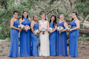 Bride with Bridesmaids in Blue Long Bridesmaids Dresses with Blue and Pink Floral Bouquets