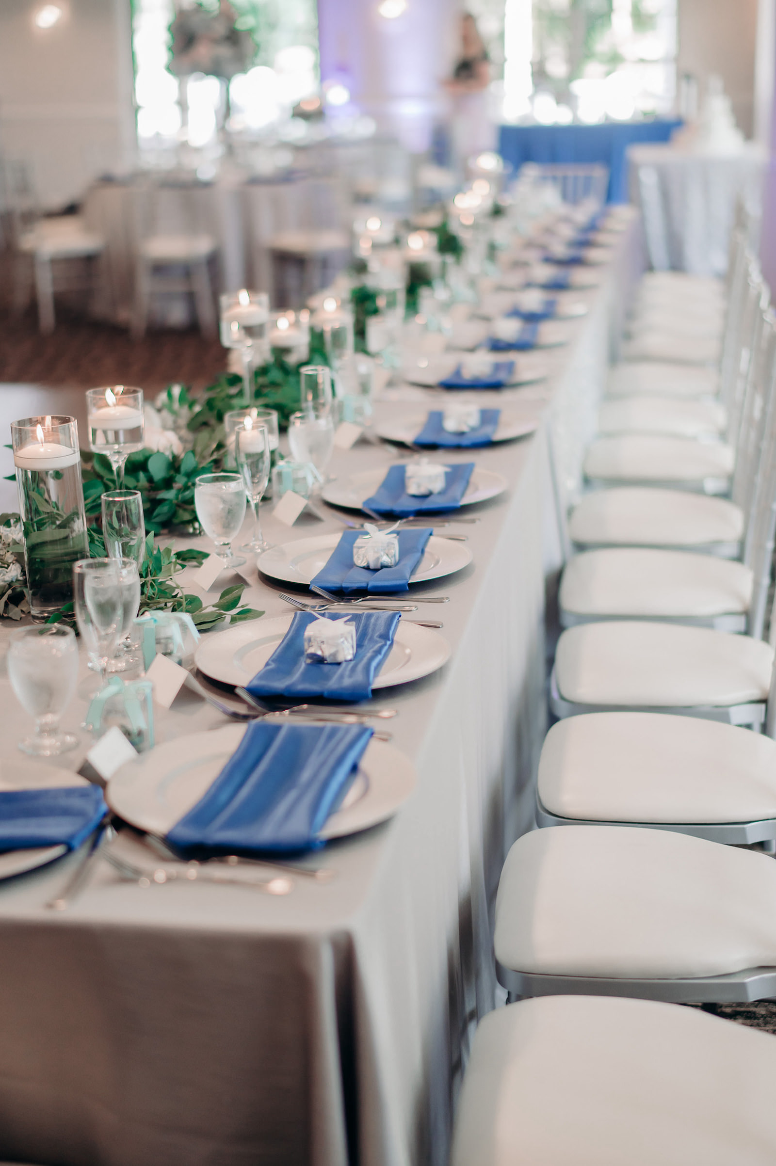 Blue Napkins and White Plating with Silver Detail Wedding Tablescape