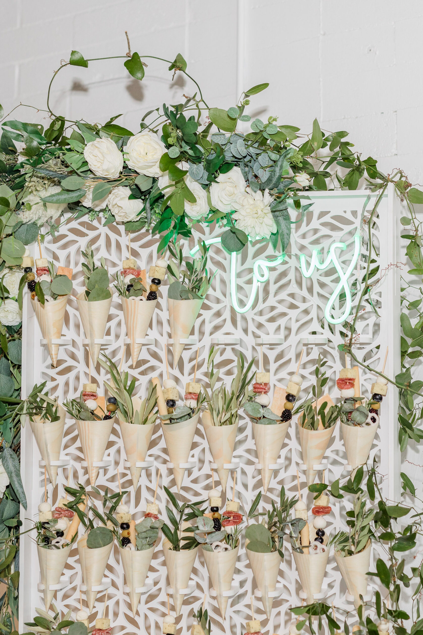 Winter Modern Whimsical Wedding Reception Decor, Unique Charcuterie Cones on Wall with Green Neon Sign, White Roses and Greenery Garland | Tampa Bay Wedding Planner MDP Wedding Events