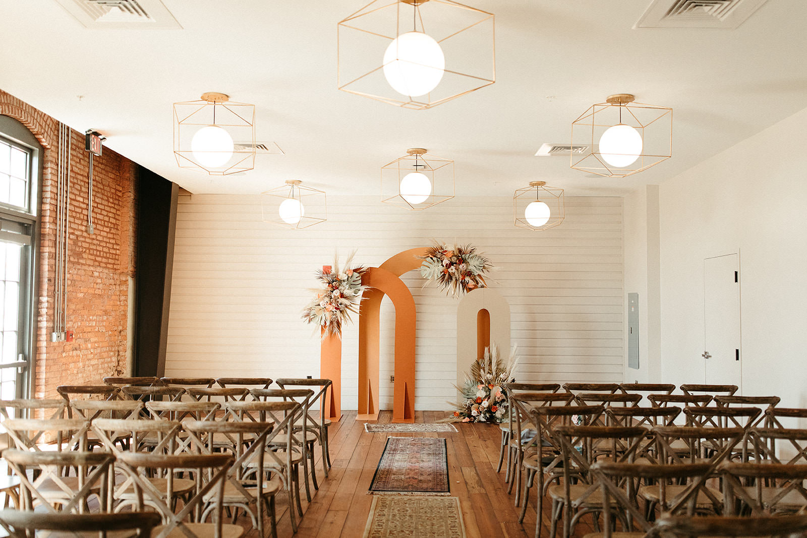 Earthy Neutral Boho Modern Chic Wedding Ceremony Decor, Wooden Cross Back Chairs, Arched Panels in Cream and Terracotta with Lush Floral Bouquets | Tampa Bay Wedding Planner Wilder Mind Events | Wedding Florist Save the Date Florida | Tampa Wedding Venue Armature Works