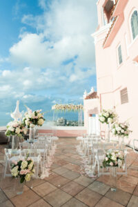 Elegant Blush Pink Same Sex Wedding Ceremony Decor, Acrylic Pedestals with Glass Vases and Lush Floral Arrangements, Pink and Ivory Roses, White Hydrangeas, Greenery Leaves, Acrylic Arch with Flowers | Tampa Bay Wedding Photographer Amanda Zabrocki Photography | Wedding Florist Save the Date Florida | Clearwater Wedding Planner Elegant Affairs by Design | Rooftop Waterfront St. Pete Wedding Venue The Don CeSar