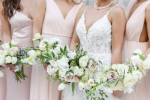 Modern Romantic Bridal Party Wearing Mix and Match Blush Pink Dresses Holding White and Mauve Roses with Greenery Floral Bouquets | Tampa Bay Wedding Attire Bella Bridesmaids