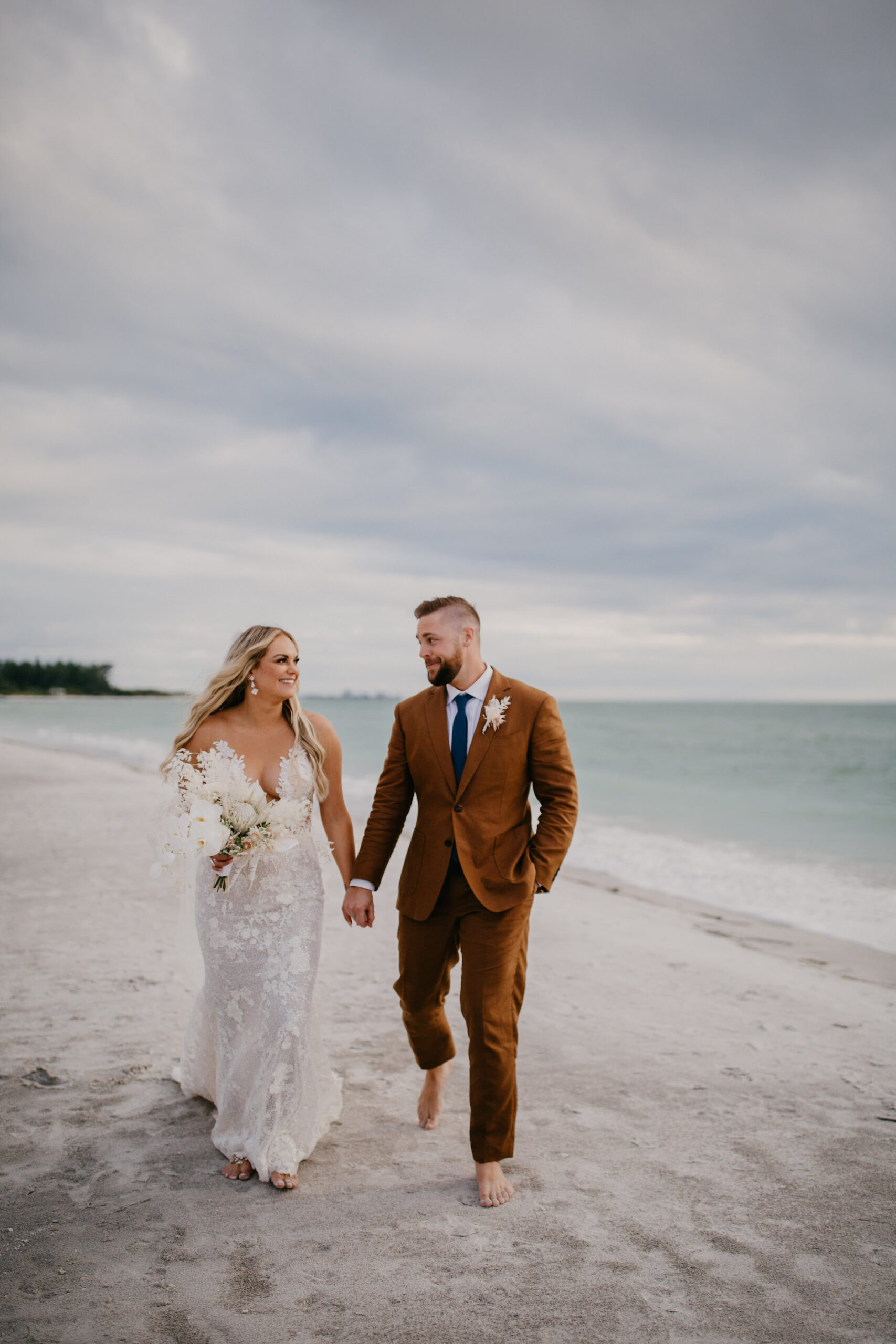 Bride and Groom Walking on the Beach Wedding Portrait