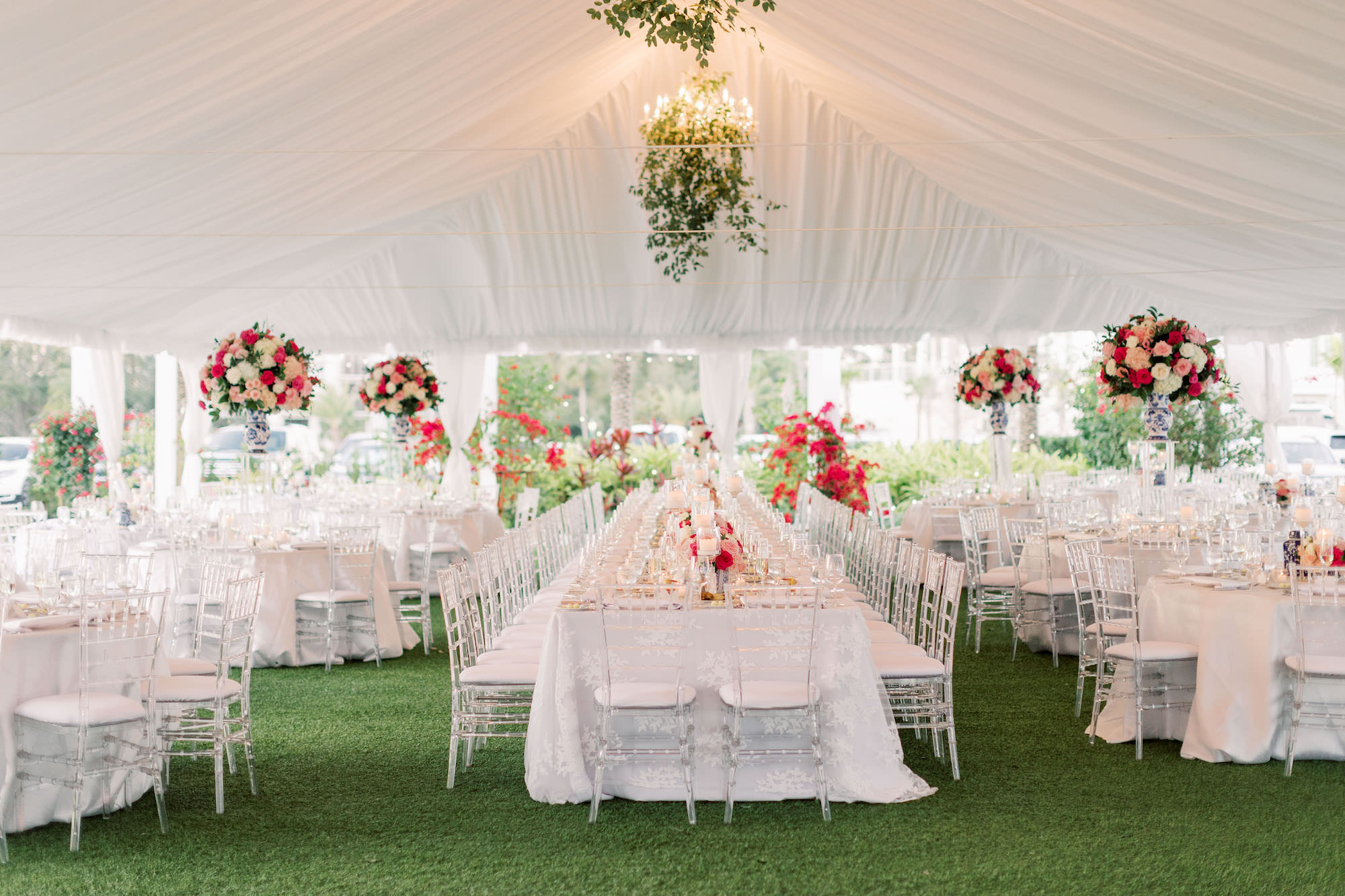 Vintage Blue and Pink Southern Classic Wedding Reception Decor, Outdoor White Tent, Long Feasting Tables with White Floral Linens, Clear Acrylic Chiavari Chairs, Greenery Hanging Chandeliers, Tall Pink and White Flowers with Greenery Floral Centerpieces, Candlesticks | Tampa Bay Wedding Planner Parties A'la Carte | Wedding Rentals Gabro Event Services | Over the Top Rental Linens | Wedding Florist Bruce Wayne Florals | Clearwater Beach Wedding Venue Belleview Inn