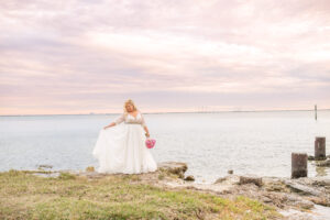 Bride in Long Sleeve Wedding Ballgown and Pink Bouquet by the Waters Wedding Portrait | Florida Photographer Kristen Marie Photography