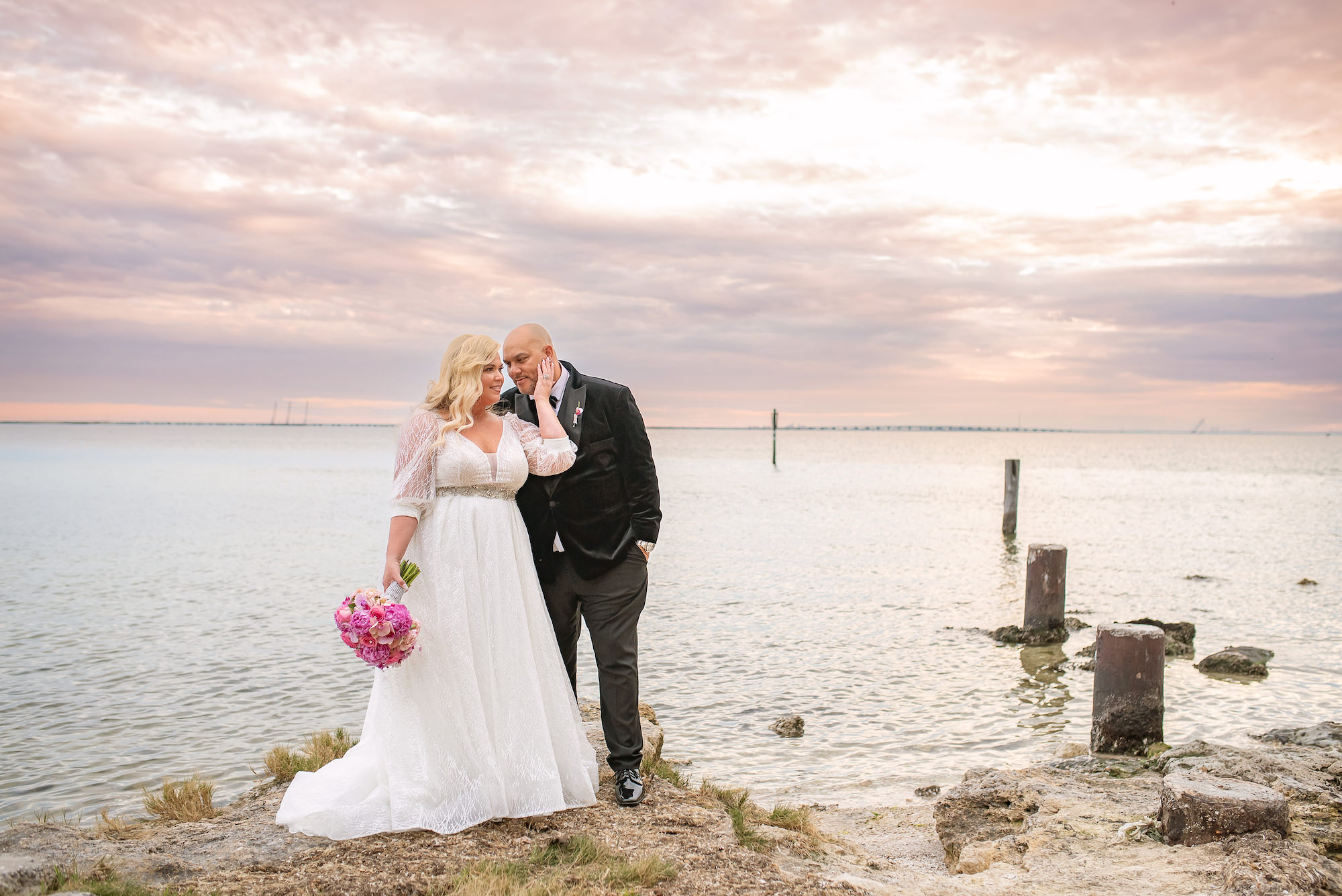 Groom and Bride in Long Sleeve Wedding Ballgown and Pink Bouquet by the Waters Wedding Portrait | Florida Photographer Kristen Marie Photography