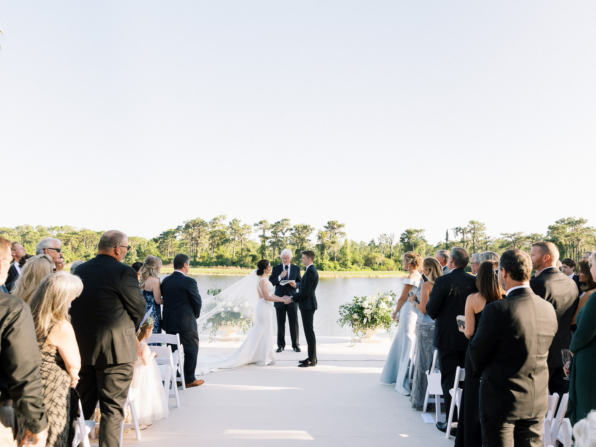 Old Florida Elegant Bride and Groom Exchanging Wedding Vows During Outdoor Wedding Ceremony | Tampa Bay Wedding Venue Concession Golf Club