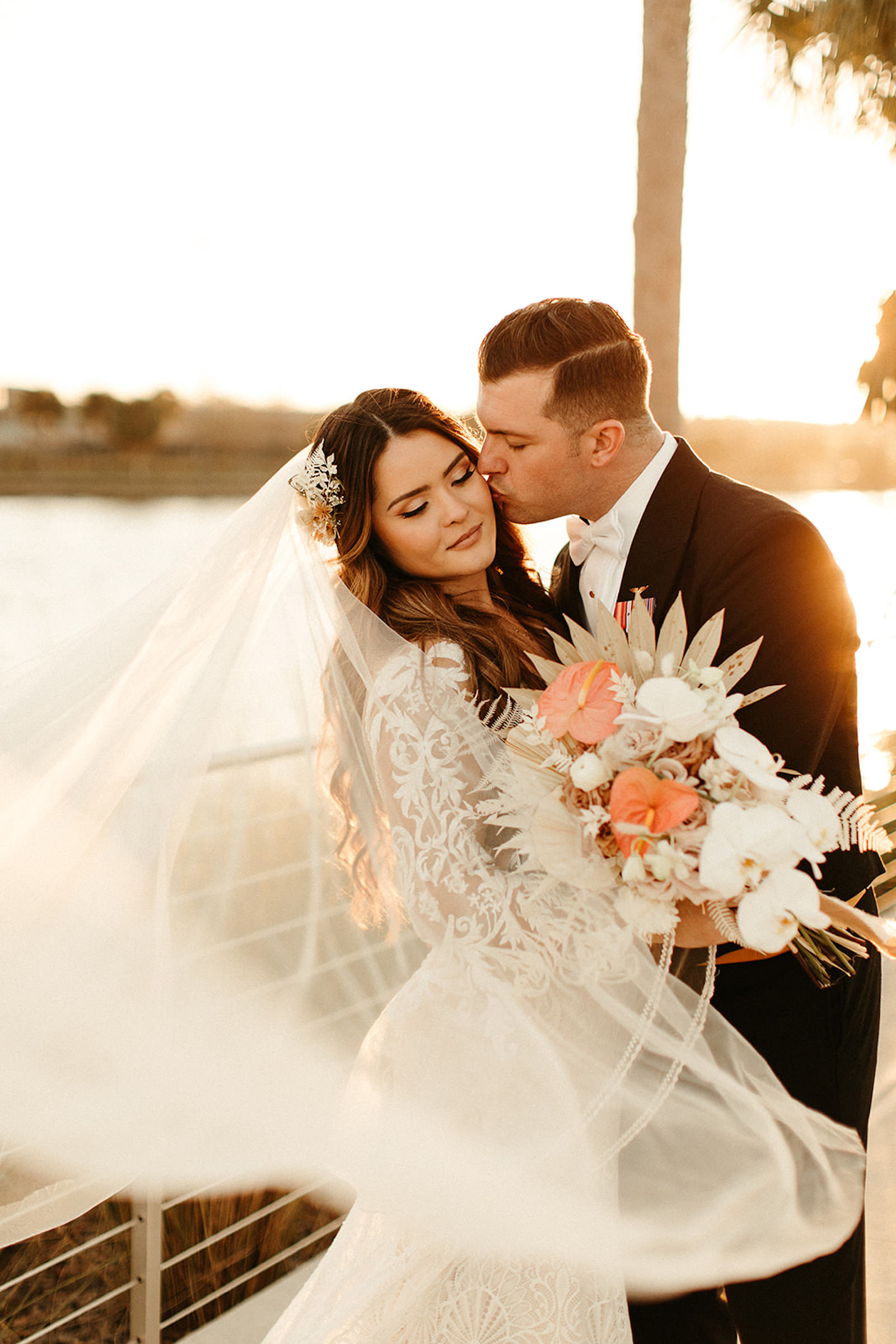 Earthy Neutral Boho Modern Chic Bride and Groom Sunset Wedding Portrait with Veil Blowing Holding Dried Leaves, White Orchids, Pink Anthuriums Floral Bouquet | Tampa Bay Wedding Florist Save the Date Florida