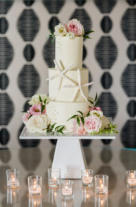 Elegant Blush Pink Same Sex Wedding Reception, Three Tier White Wedding Cake with Starfish Fondant Pieces, Blush Pink and Ivory Roses | Tampa Bay Wedding Photographer Amanda Zabrocki Photography
