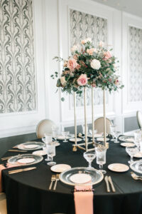 Elegant Reception Ideas | Tall Pink White and Greenery Centerpiece with Black Linens, Clear Plates and Pink Napkins | St. Pete Rentals Outside the Box Event Rentals