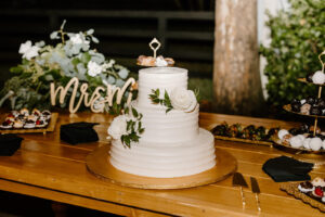 Three Tier White Wedding Cake with White Floral Details with Greenery