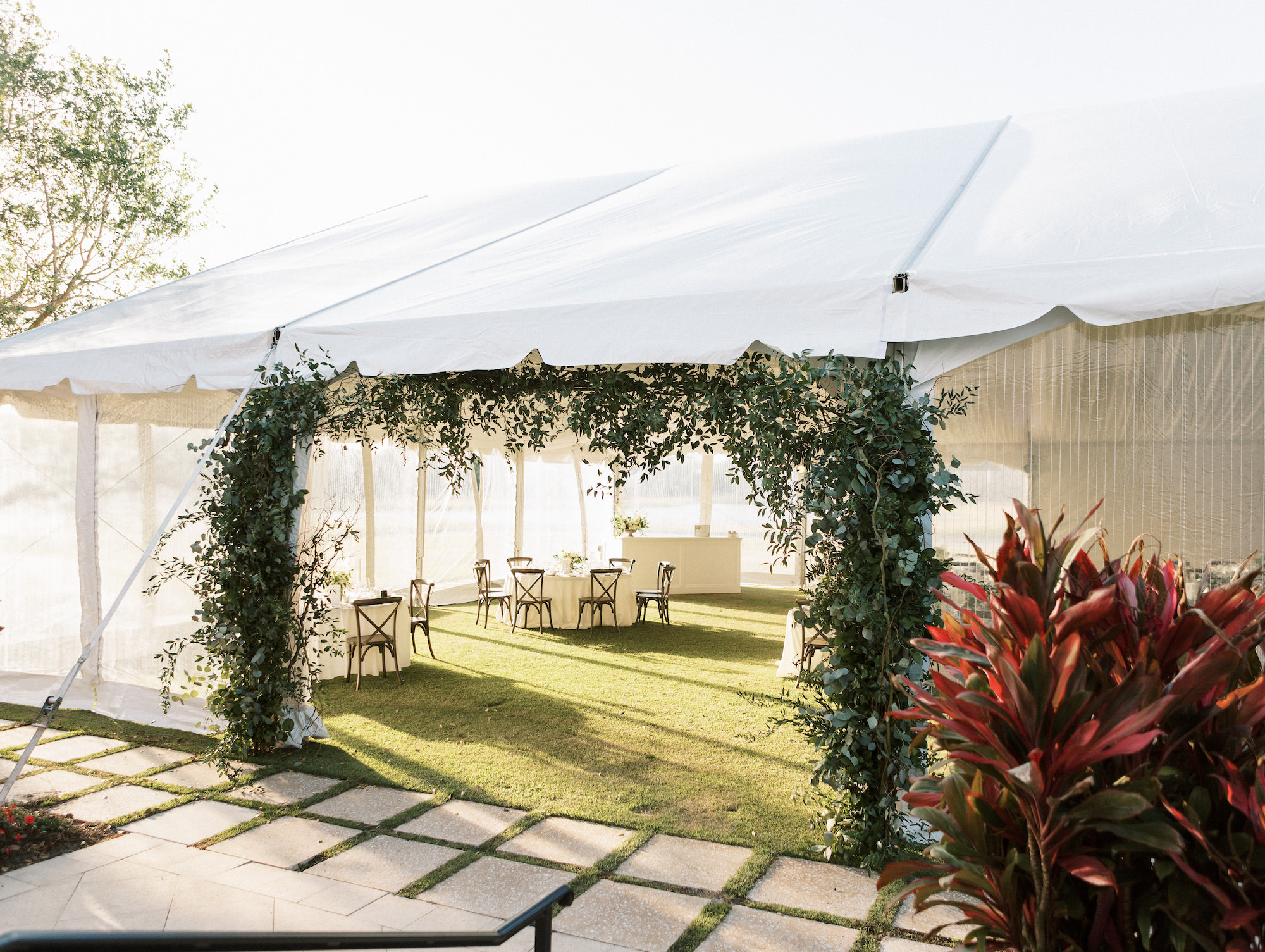 Old Florida Elegant Outdoor White Tent Wedding with Greenery Entrance