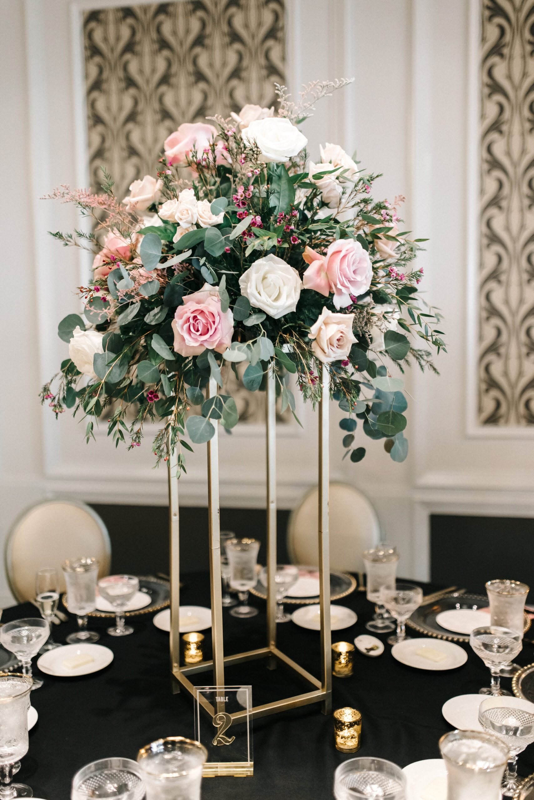 Elegant Reception Ideas | Tall Pink White and Greenery Centerpiece with Black Linens, Clear Plates and Pink Napkins | St. Pete Rentals Outside the Box Event Rental