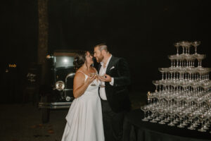 Bride and Groom with Champagne Tower at Wedding Reception