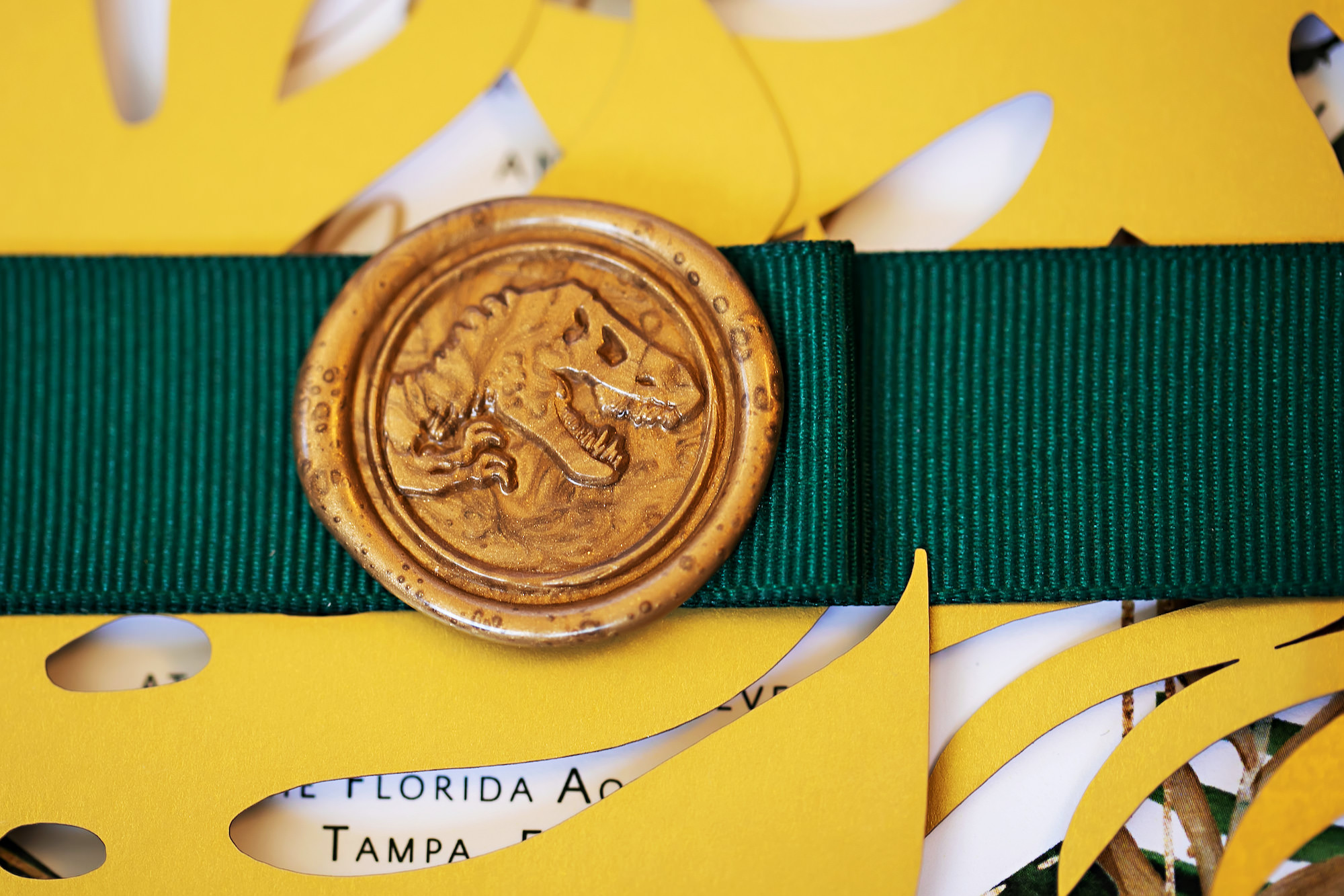 Dinosaur Inspired Gold Custom Letter Seal on Green Ribbon Wedding Invitation