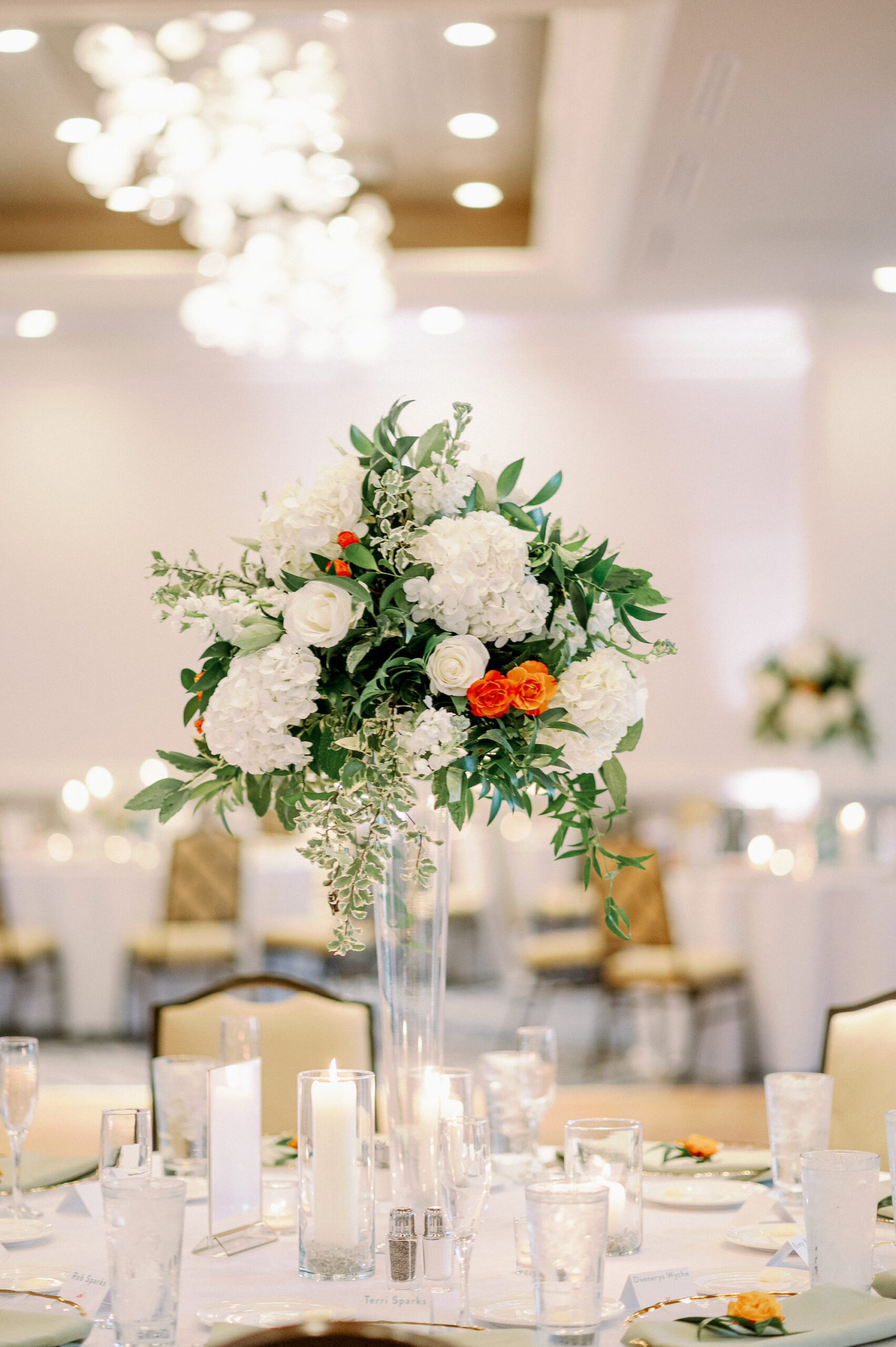 Tall Floral Centerpieces with White and Orange Florals and Greenery