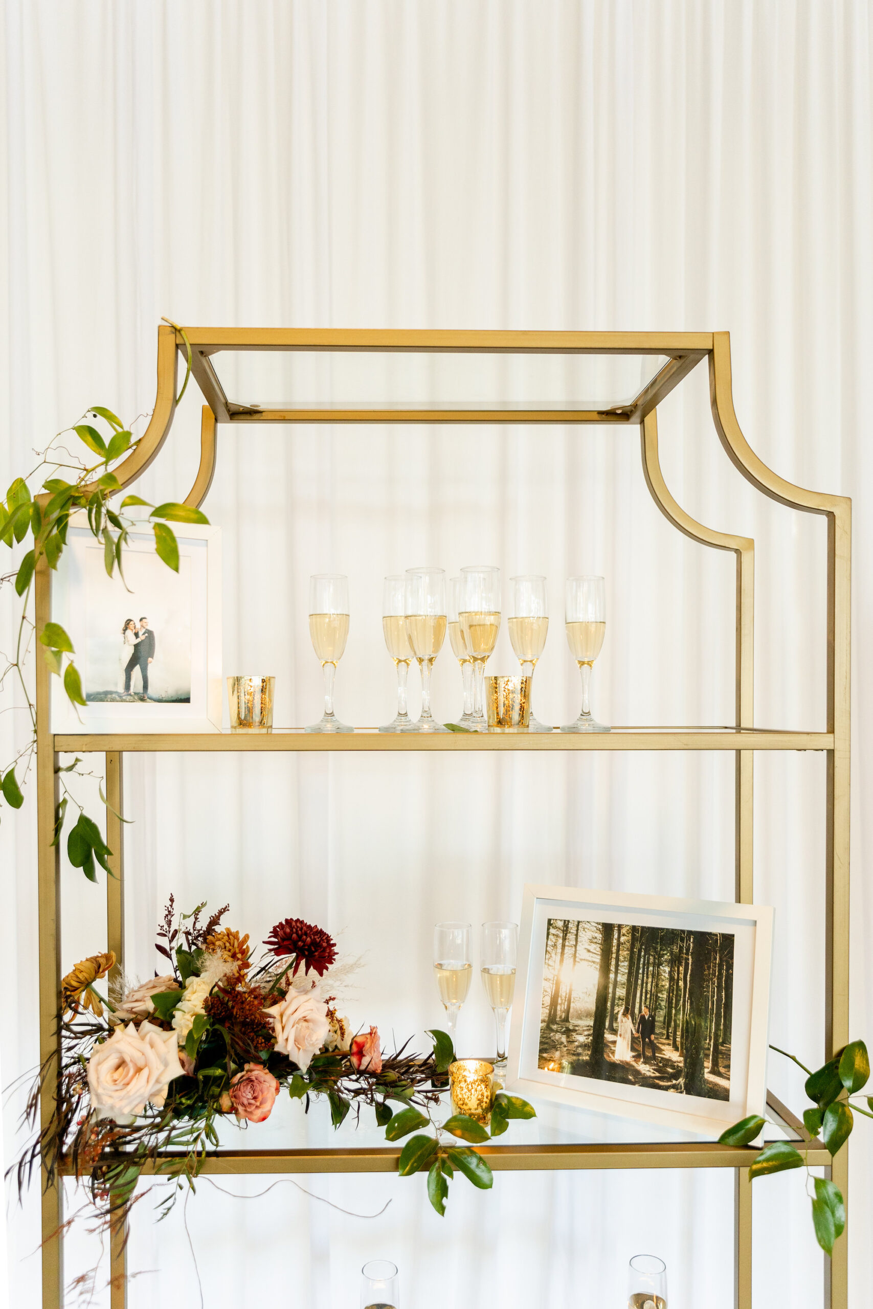 Fall Boho Wedding Ceremony Decor, Tall Gold Shelving with Champagne Welcome Glasses and Fall Colored Floral Bouquet | Tampa Bay Wedding Rentals Gabro Event Services