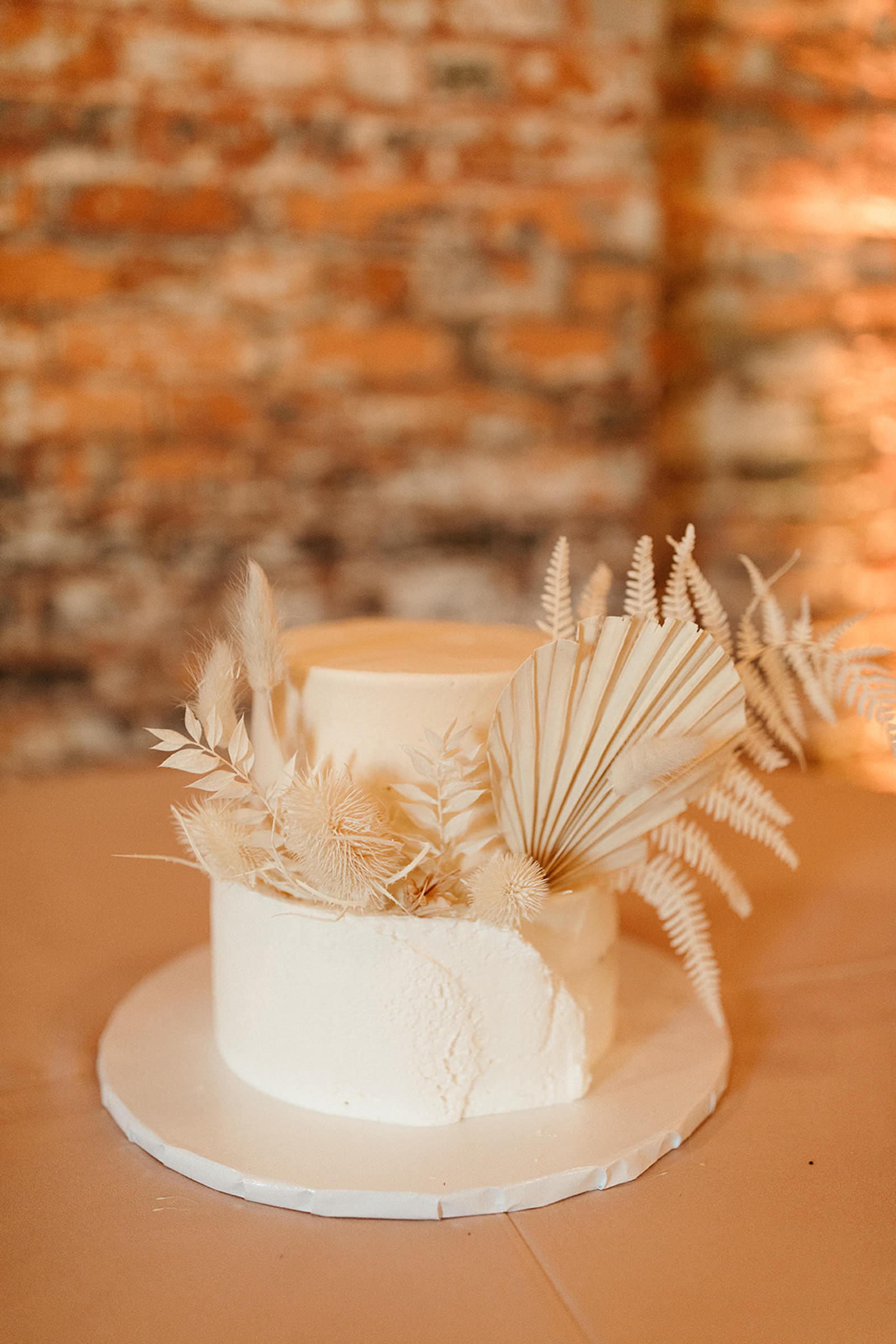 Earthy Neutral Boho Modern Chic Wedding, Two Tier White Wedding Cake with Dried Leaves | Tampa Bay Wedding Florist Save the Date Florida