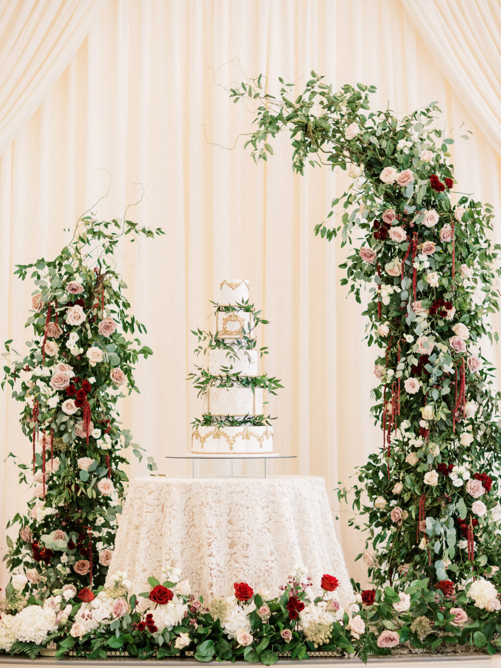 Elegant Royal Glam Gatsby Wedding Reception Decor, Lush Greenery, Mauve, Blush Pink, White and Burgundy Roses, Red Hanging Amaranthus Floral Pillars, Five Tier White and Gold Wedding Cake with Greenery Leaves | Tampa Bay Wedding Cake The Artistic Whisk | St. Pete Wedding Planner John Campbell Weddings