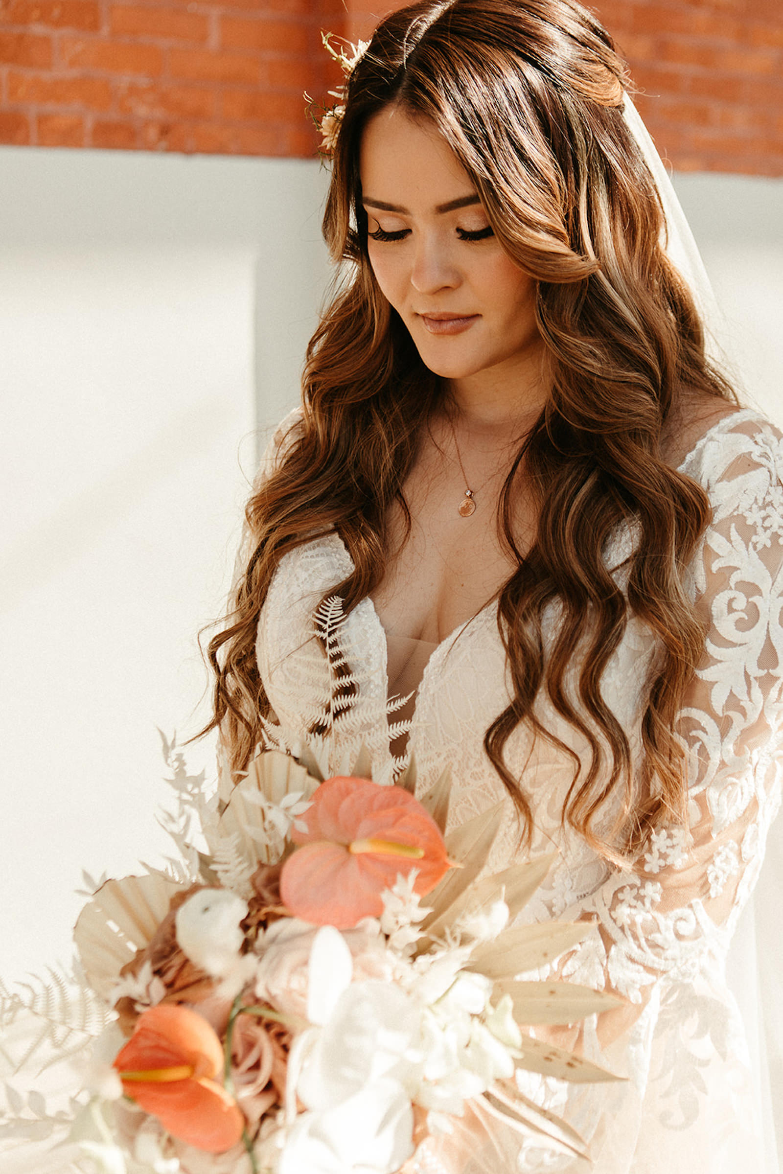 Earthy Neutral Boho Modern Chic Bridal Beauty Portrait Wearing Lace and Illusion Bell Sleeve Wedding Dress Holding White Orchids, Dried Leaves and Pink Anthurium Floral Bouquet | Tampa Bay Wedding Florist Save the Date Florida | Femme Akoi Beauty Studio