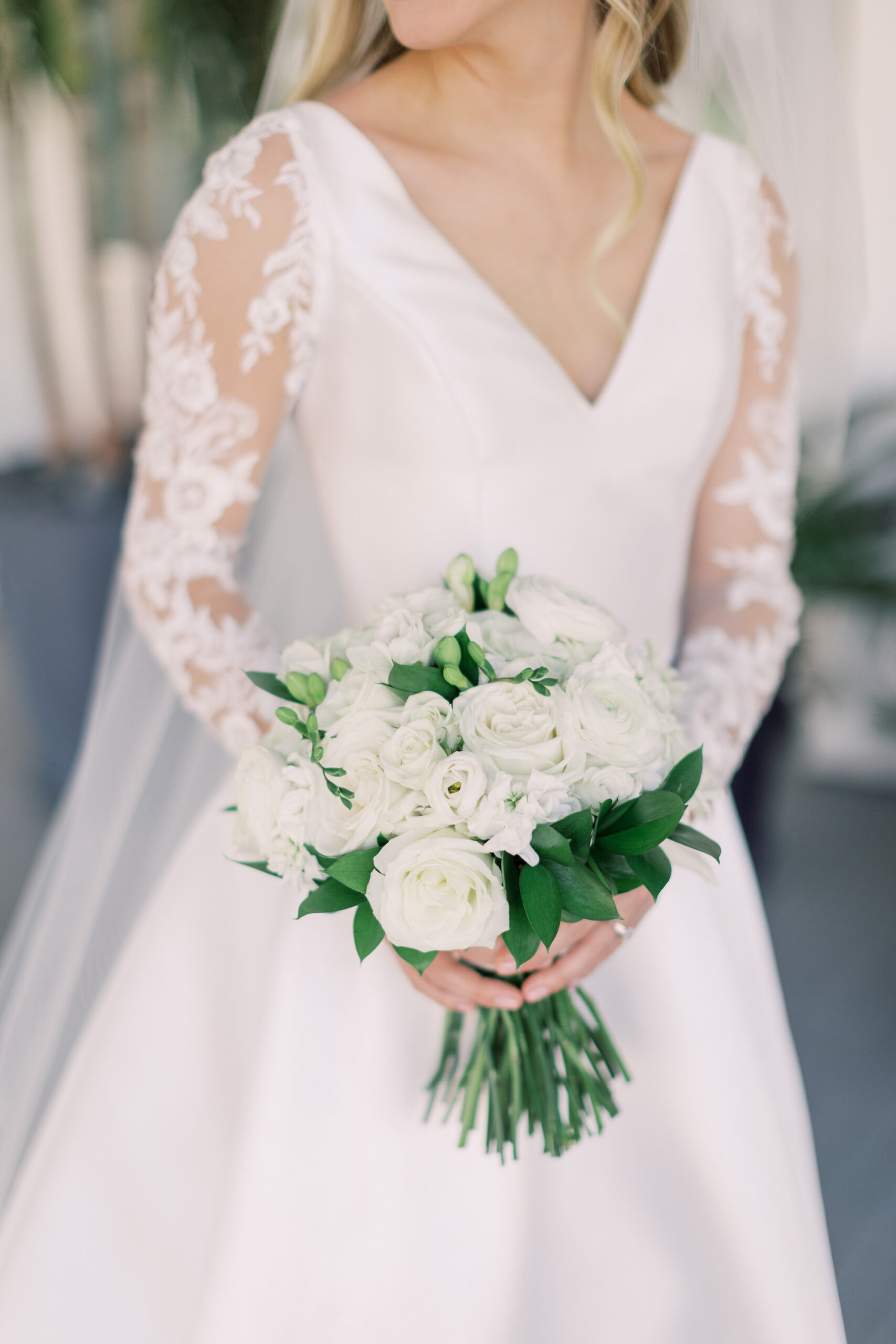 Vintage Blue Wedding, Tampa Bride Wedding Portrait Wearing Silk V Neckline Wedding Dress with Lace and Illusion Long Sleeves Holding White Roses and Greenery Floral Bouquet | Tampa Bay Wedding Florist Bruce Wayne Florals