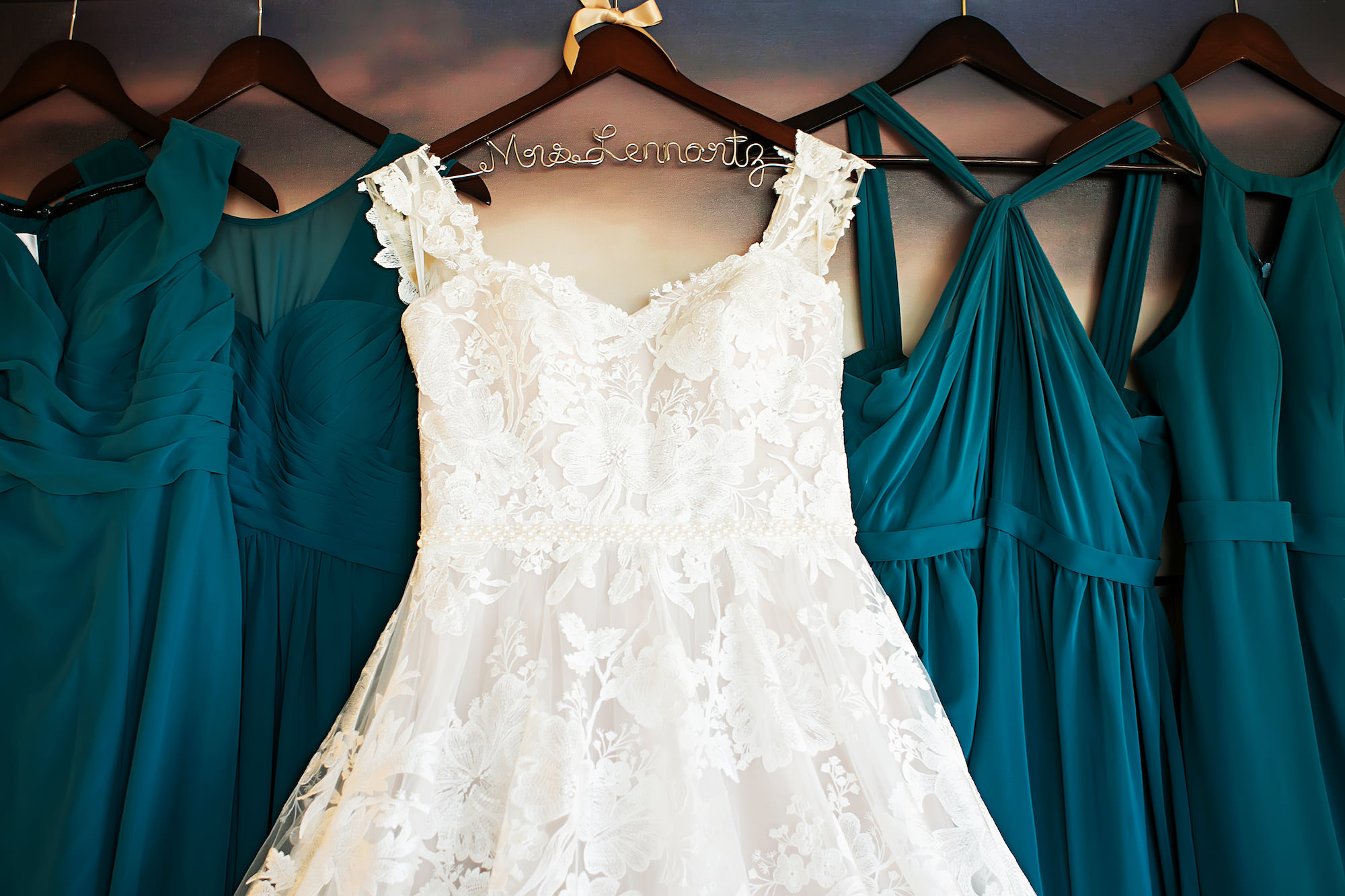 Lace Wedding Ballgown Hanging Next to Teal Bridesmaids Dresses Wedding Portrait | Tampa Photographer Limelight Photography