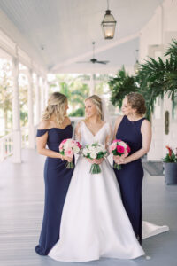Vintage Blue Tampa Wedding, Bride Wearing Lace and Illusion Long Sleeve Wedding Dress Holding All White Floral Bouquet with Bridesmaids in Navy Blue Mix and Match Dresses Holding White and Pink Floral Bouquets | Tampa Bay Wedding Florist Bruce Wayne Florals