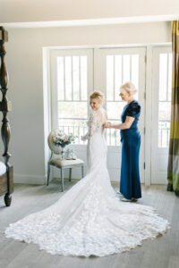 Blue Mother of the Bride Dress Zipping Up Daughter in Wedding Dress Portrait | Tampa Hair and Makeup Artist Femme Akoi