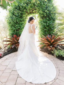 Old Florida Elegant Bride Wearing Classic White Wedding Dress with Open Back and Full Length Veil
