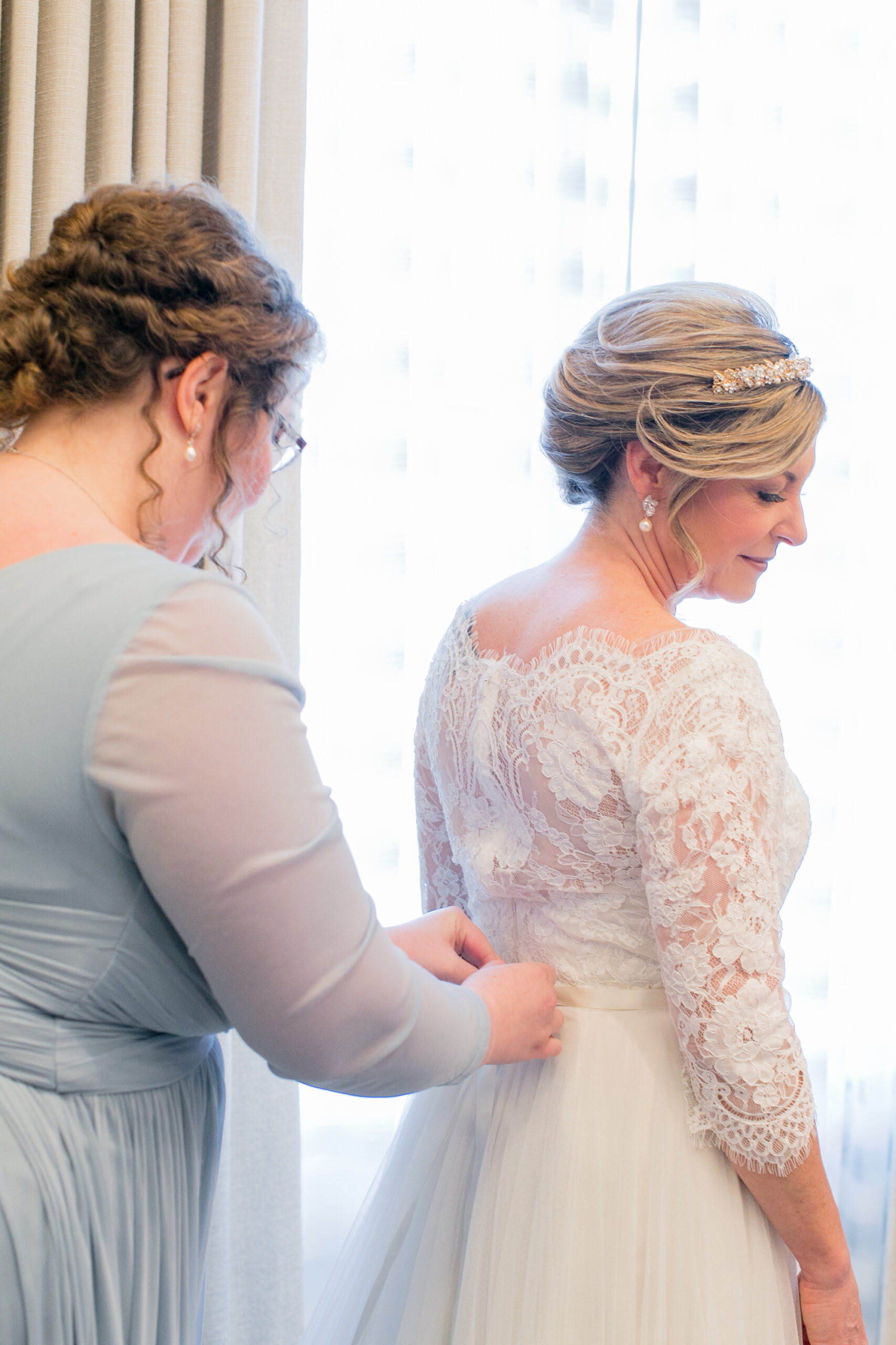 Classic Bride with Maid of Honor Buttoning Wedding Dress | Tampa Bay Wedding Photographer Carrie Wildes Photography | St. Pete Wedding Hair and Makeup Adore Bridal