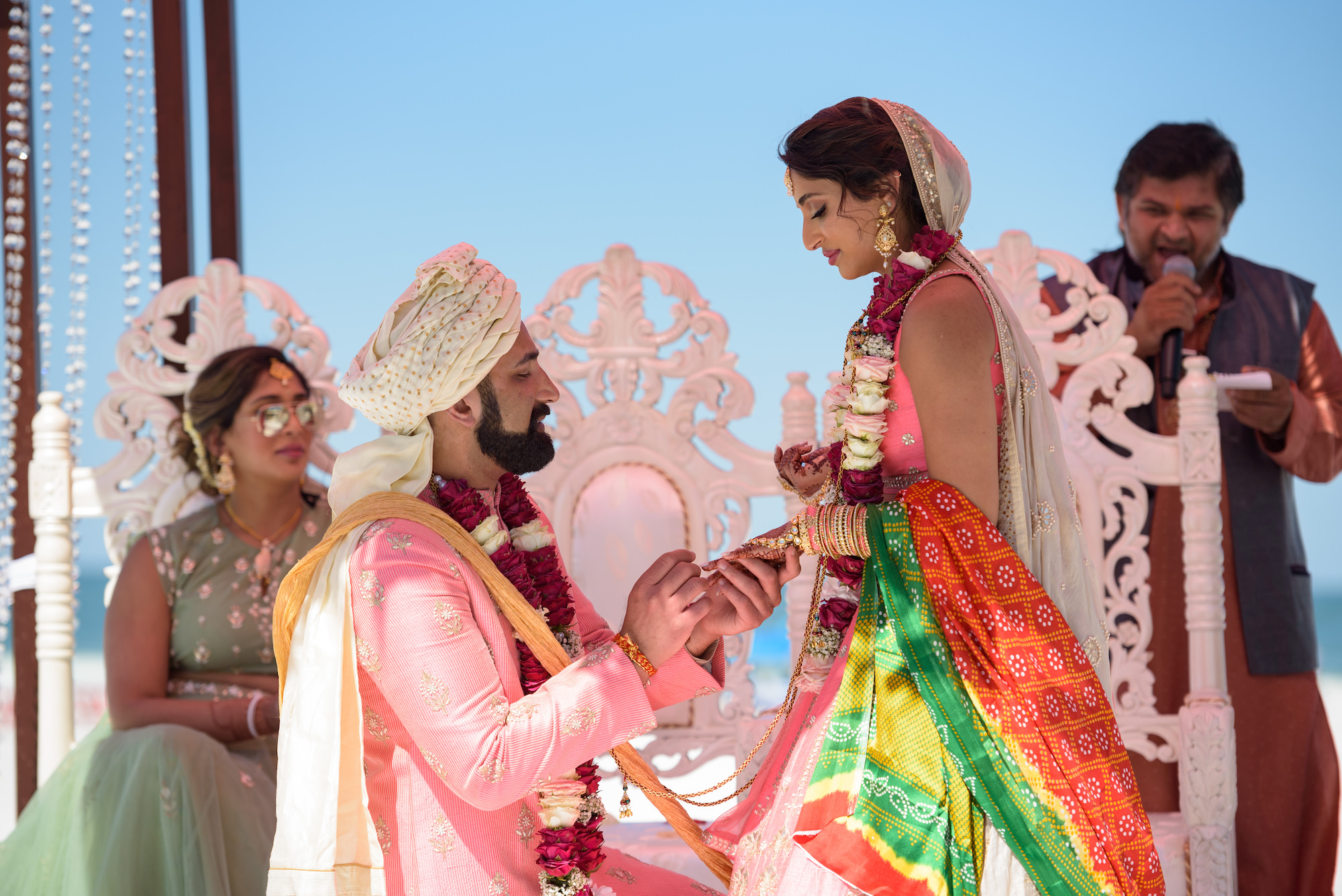 Bride and Groom During Traditional Hindu Wedding Ceremony, Wearing Indian Lehenga and Sari, Groom Wearing Bright Pink and Gold Sherwani and Turban | Florida Hair and Makeup Artists Michele Renee the Studio