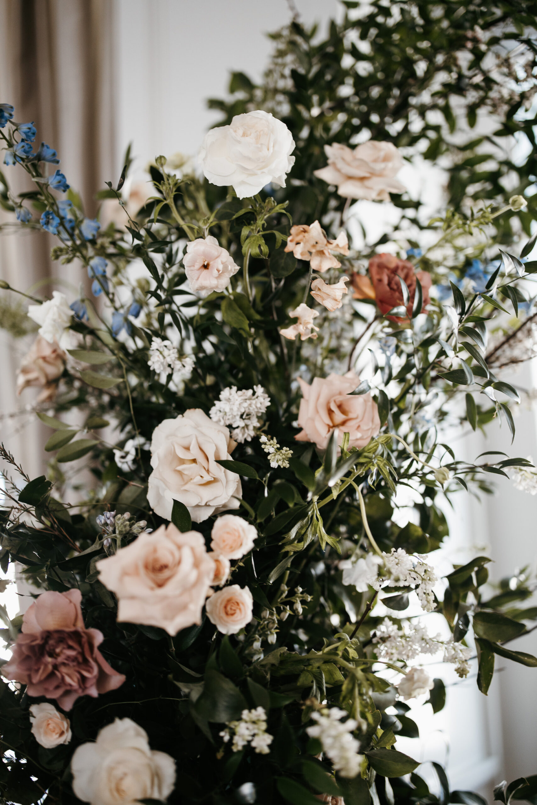 Whimsical Blue Delphinium Pastel Rose Wedding Ceremony Arch Floral Arrangements | Garden Wedding Inspiration