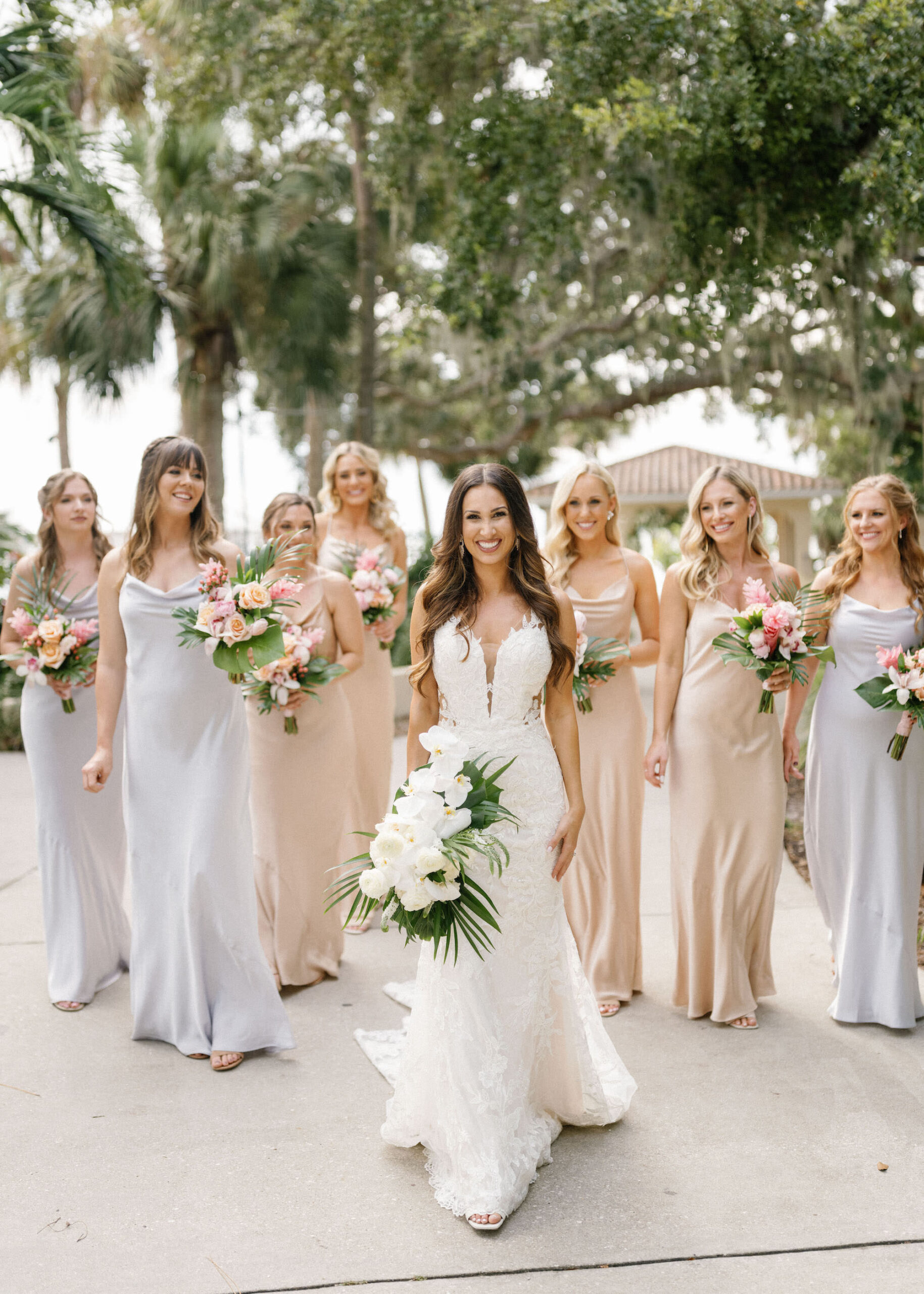 Luxurious Classic Wedding, Bridesmaids Wearing Matching Champagne and Silver Silk Dresses Holding Tropical Floral Bouquets | Tampa Wedding Florist Botanica International Design Studio