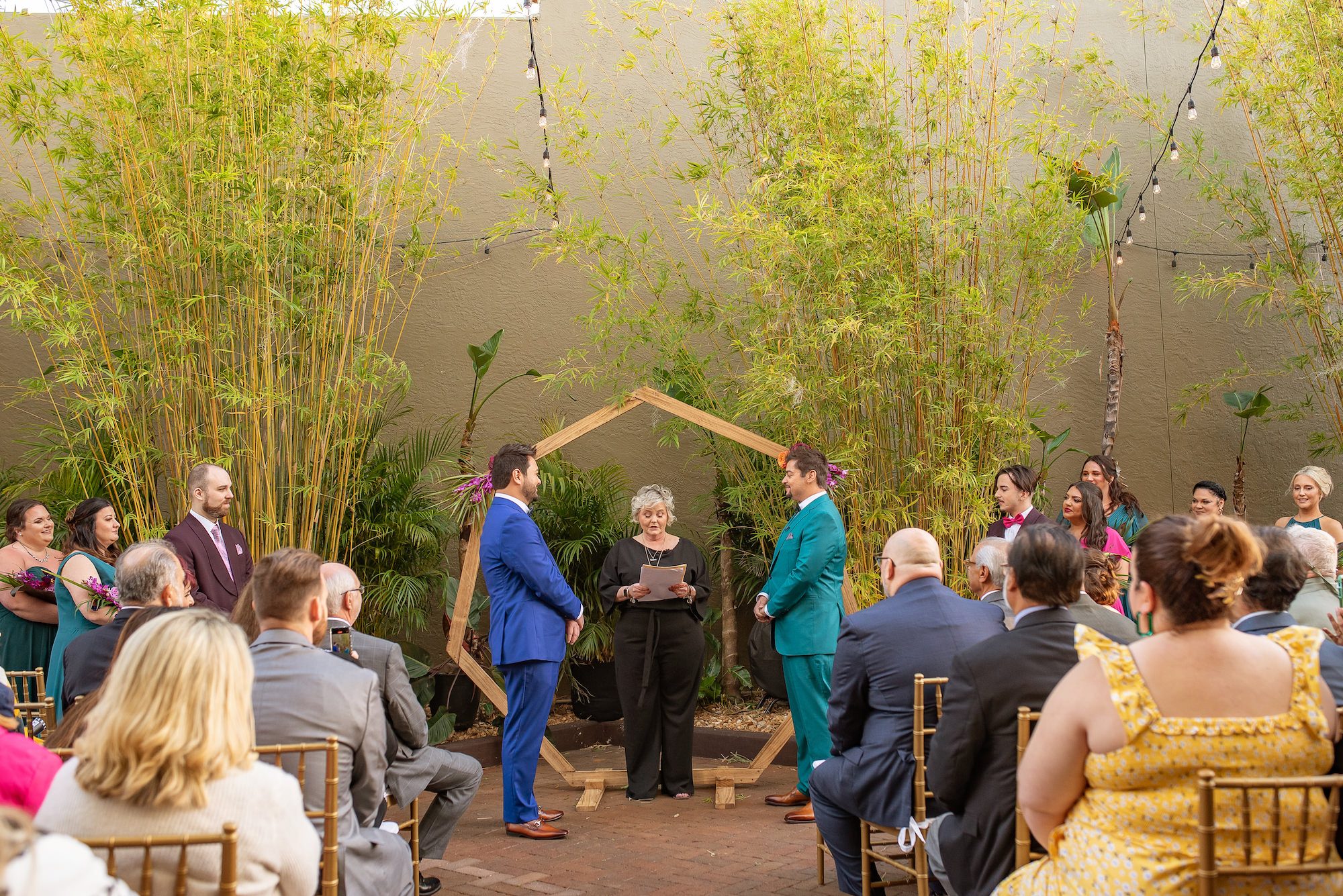 Groom and Groom Exchanging Vows in Tropical Industrial Wedding Ceremony | St. Petersburg Wedding Venue Nova 535 | Florida Photographer Kristen Marie Photography