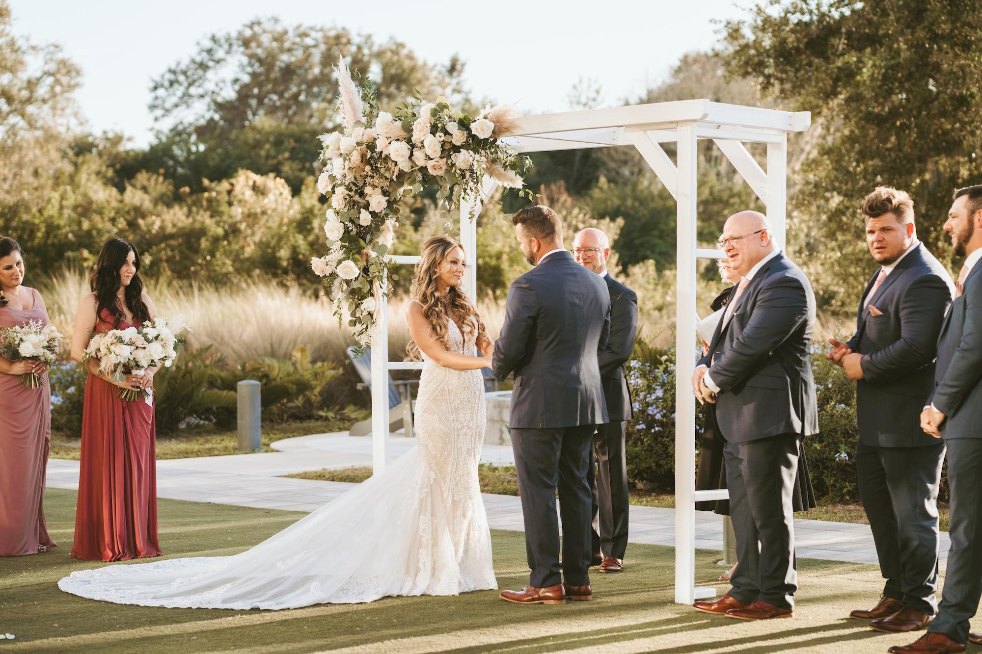 Bride and Groom Exchanging Vows in Outdoor Wedding Ceremony on Golf Course with Classic Details and Elegant Florals | Tampa Wedding Photographer Mars and The Moon Films