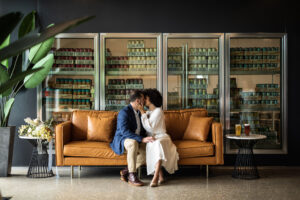 Modern Whimsical Wedding, Bride and Groom Sitting on Brown Retro Leather Couch | Tampa Bay Unique Wedding Venue Florida Ave Brewing