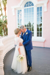 Classic Bride and Groom First Look Wedding Portrait on Balcony of Historic St. Pete Wedding Venue The Don CeSar | Tampa Wedding Photographer Carrie Wildes Photography | Wedding Hair and Makeup Adore Bridal