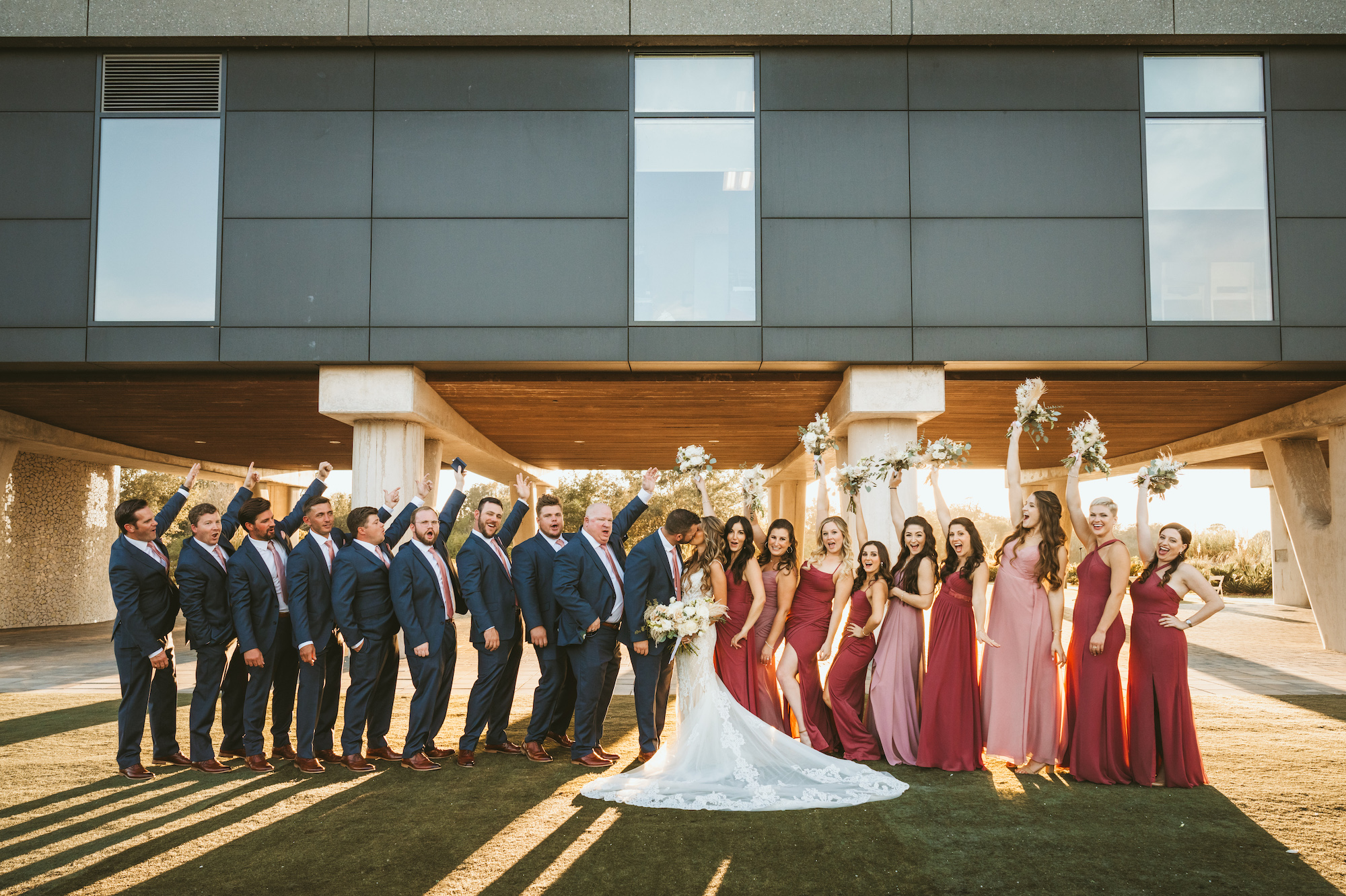 Bridal Party in Black Suits and Shades of Red and Pink Bridesmaids Dresses Portrait | Florida Photographer Mars and The Moon Films