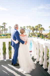 Classic Bride and Groom First Look Wedding Portrait on Balcony of Historic St. Pete Wedding Venue The Don CeSar | Tampa Wedding Photographer Carrie Wildes Photography | Wedding Hair and Makeup Adore Bridal