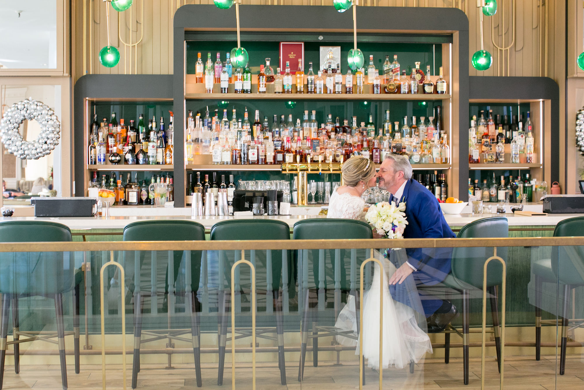 Classic Bride and Groom Sitting at Bar at Historic St. Pete Wedding Venue The Don CeSar | Tampa Bay Wedding Photographer Carrie Wildes Photography
