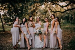 Boho Vintage Bride with Bridesmaids in Mix and Match Taupe Dresses Holding Dried Flowers Bouquets | Tampa Wedding Venue Mill Pond Estate