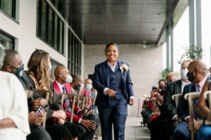 Vibrant Same Sex Lesbian Wedding, Bride Wearing Blue Suit Walking Down the Wedding Ceremony Aisle | Tampa Bay Wedding Photographer Dewitt for Love Photography | Wedding Hair and Makeup IDBM Artistry