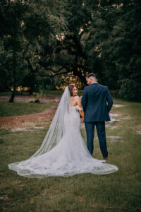 Boho Vintage Bride with Full Length Wedding Veil and Groom Wedding Portrait Outdoors | Tampa Bay Wedding Venue Mill Pond Estate